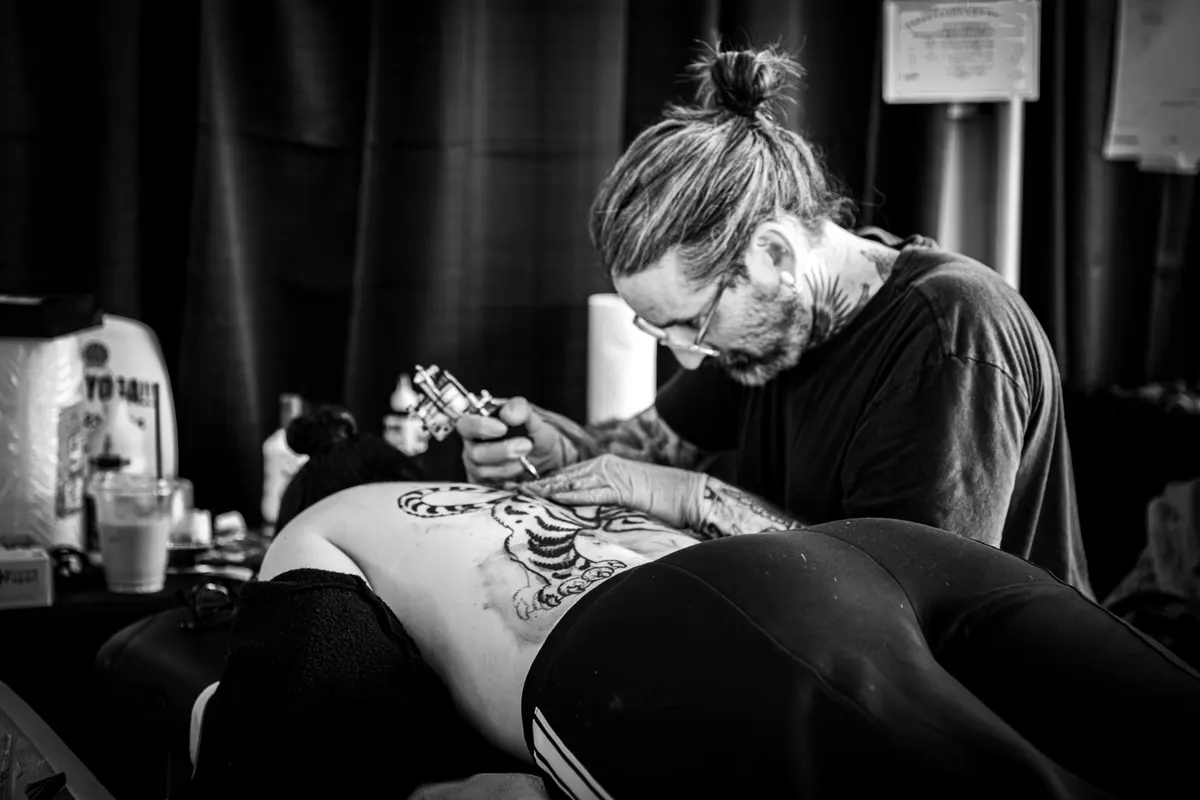 Tattoo artist working at VOID Tattoo Fest.